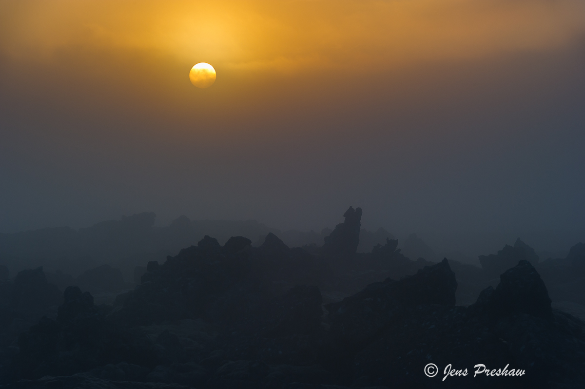 This tortured black lava field was covered in mist early in the morning. As the sun rose, standing in this landscape was like...