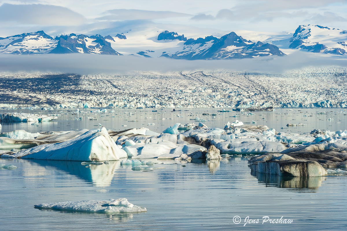 I like the the thin band of clouds in this image. The blue icebergs, glacier and mountains give the photo a real sense of depth...